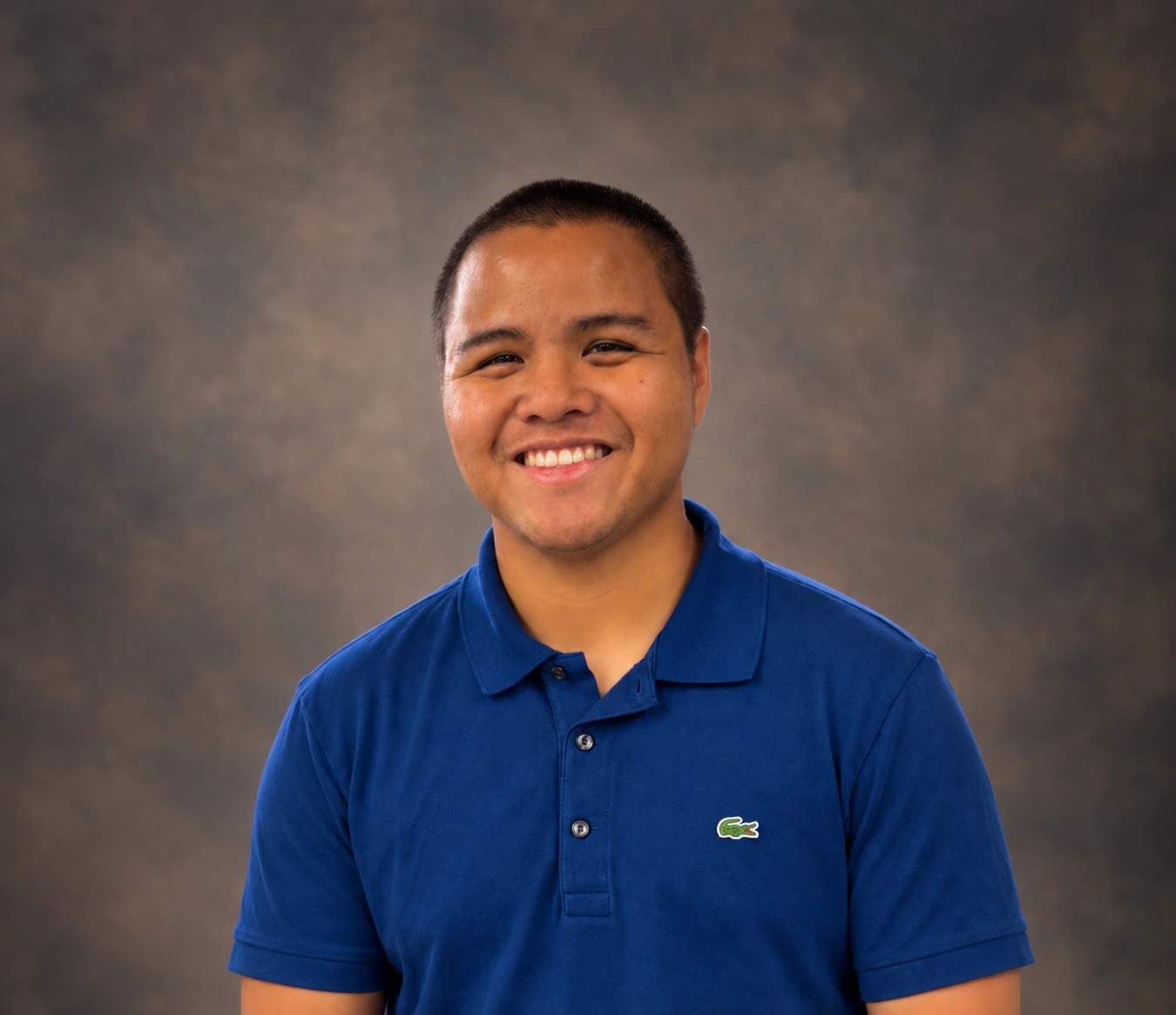 Jamil Tolentino smiling in a blue polo
